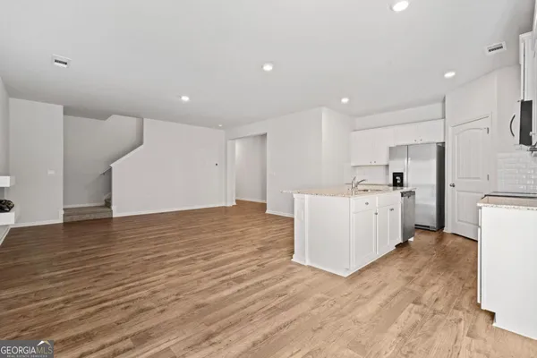 a view of a kitchen with wooden floor