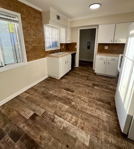 a room with a refrigerator and a window