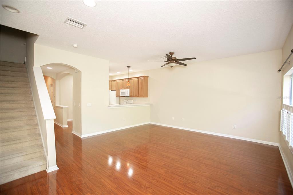 11919 Essington Street New Port Richey, FL 34654 - Photo 9 of 46 a view of a room with wooden floor and white walls