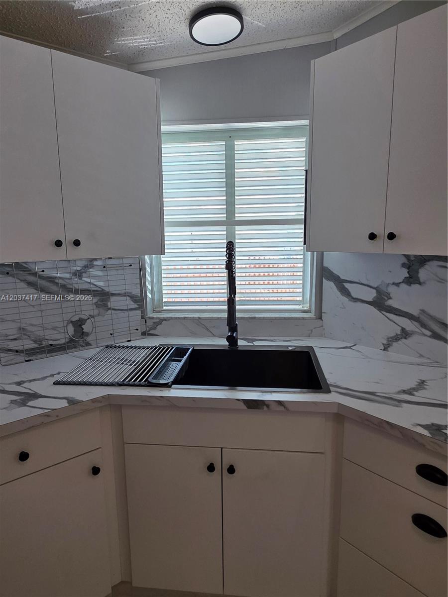 17350 Southwest 232nd Street, Unit 47 Miami, FL 33170 - Photo 6 of 9 a kitchen with a sink and a window