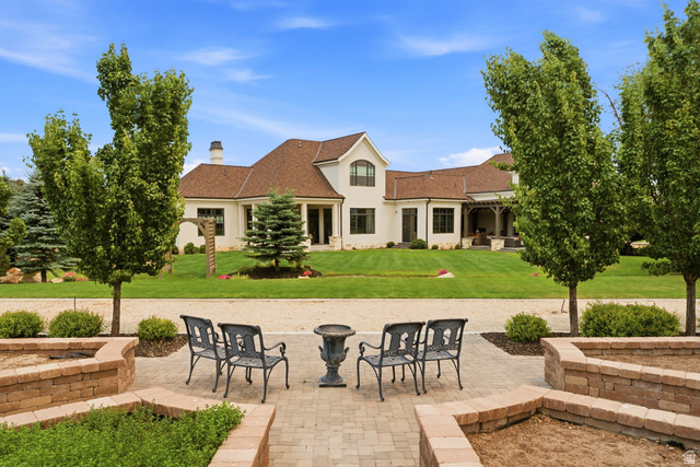 71 Farm Road Midway, UT 84049 - Photo 91 of 92 Expansive outdoor patio area featuring paver flooring, curved brick planters, and mature trees