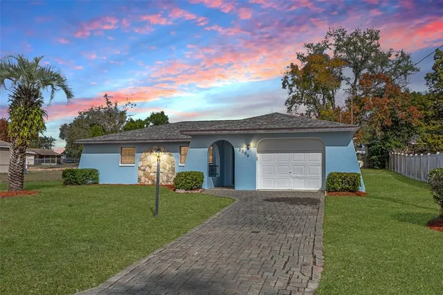 a front view of a house with a yard and garage