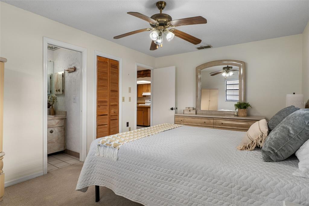 2300 Restmere Lane Spring Hill, FL 34609 - Photo 14 of 28 a bedroom with a bed and a chandelier