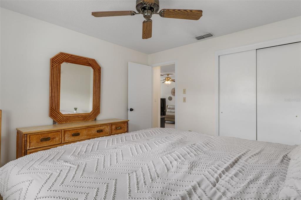 2300 Restmere Lane Spring Hill, FL 34609 - Photo 18 of 28 a bedroom with a bed and a dresser