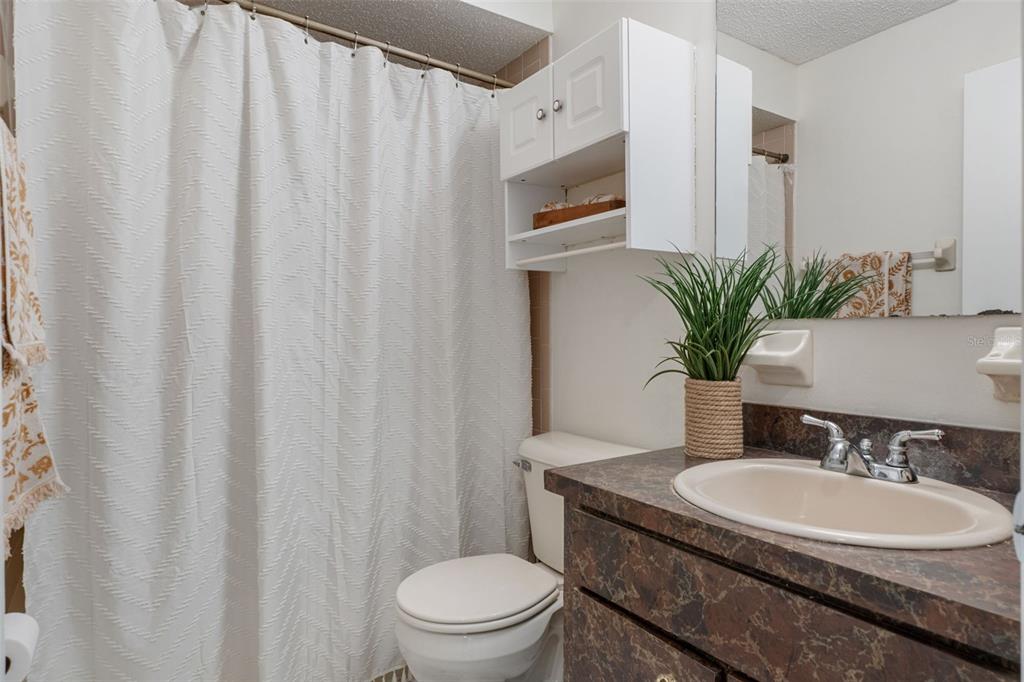 2300 Restmere Lane Spring Hill, FL 34609 - Photo 19 of 28 a bathroom with a granite countertop sink and a mirror