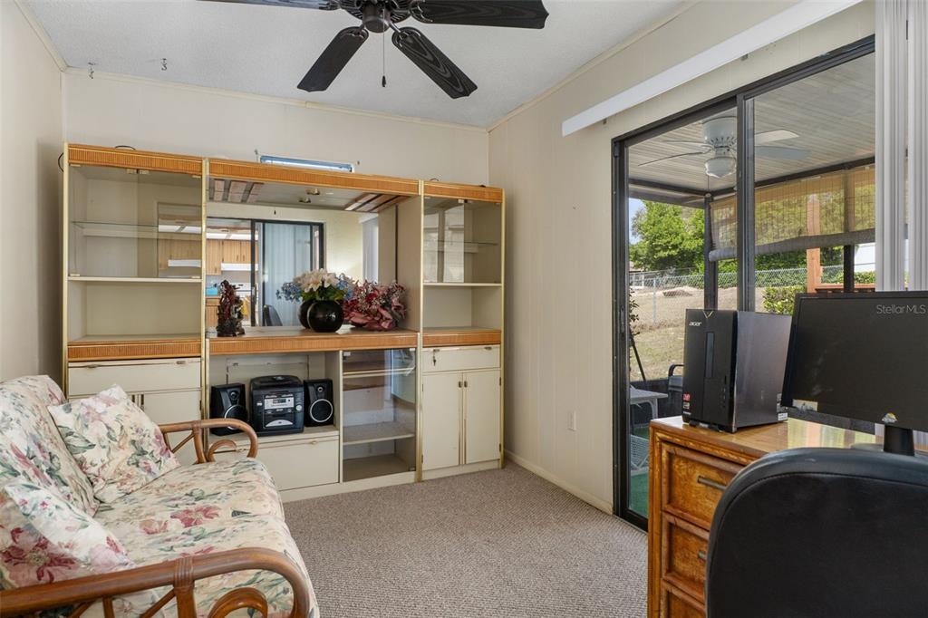 2300 Restmere Lane Spring Hill, FL 34609 - Photo 20 of 28 a living room with furniture and a flat screen tv