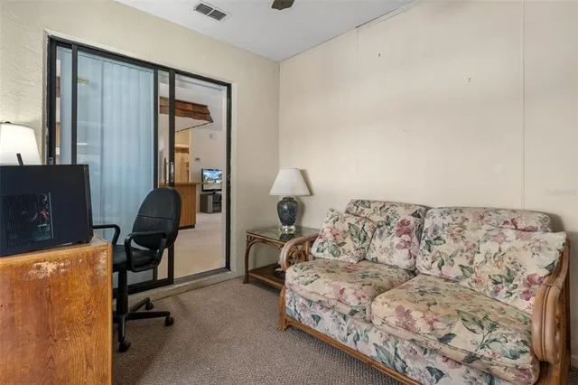 a living room with a bed furniture and a window
