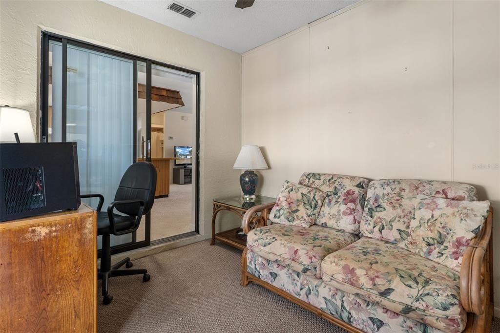 2300 Restmere Lane Spring Hill, FL 34609 - Photo 21 of 28 a living room with a bed furniture and a window