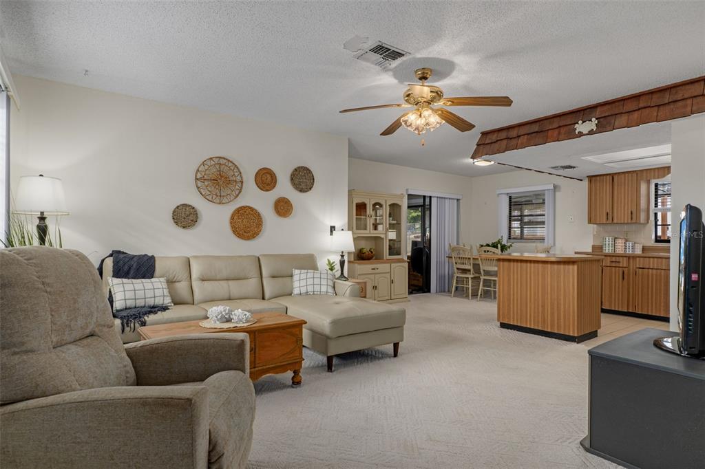 2300 Restmere Lane Spring Hill, FL 34609 - Photo 5 of 28 a living room with furniture and a chandelier