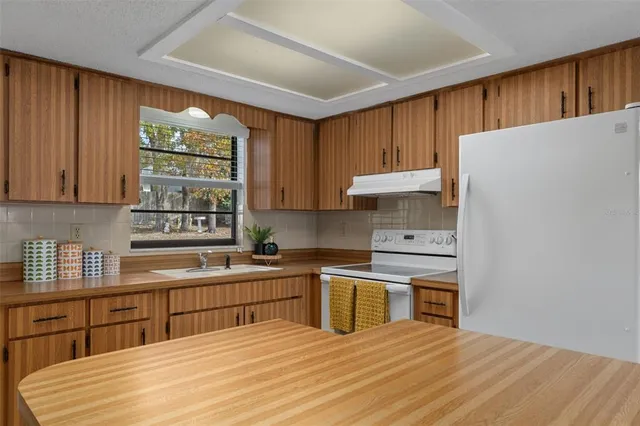 a kitchen with stainless steel appliances granite countertop a sink cabinets and a counter top space
