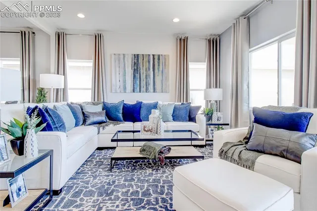 a living room with furniture and windows