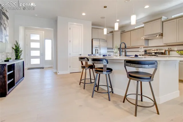 a kitchen with stainless steel appliances kitchen island a large counter top space and a center island