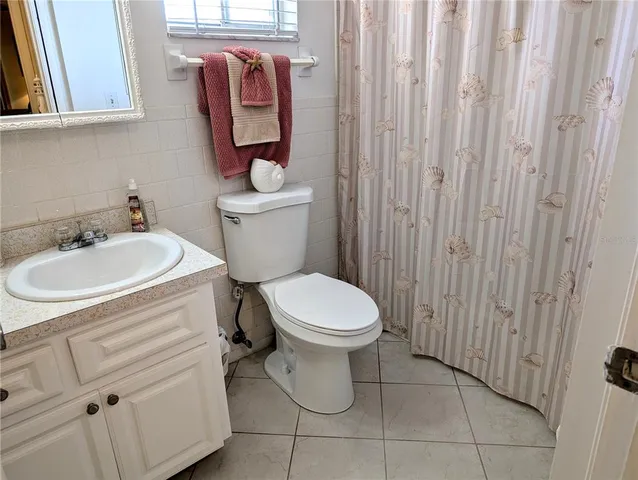 a white toilet sitting next to a bathroom sink