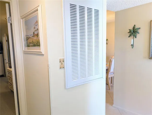a view of a hallway with windows and painted walls