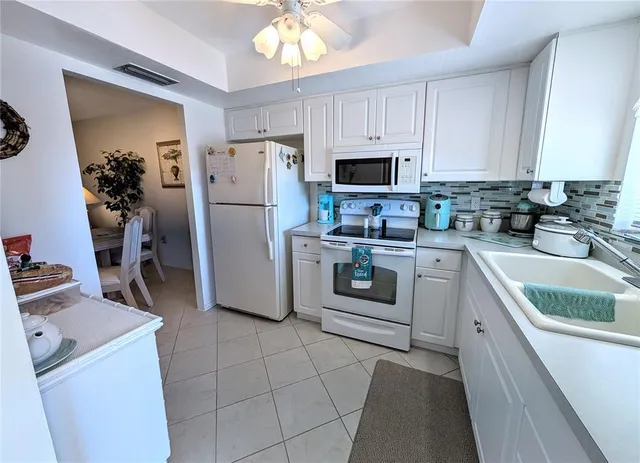 a kitchen with a sink a stove and refrigerator