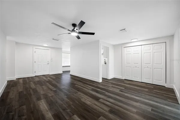 a view of an empty room with wooden floor