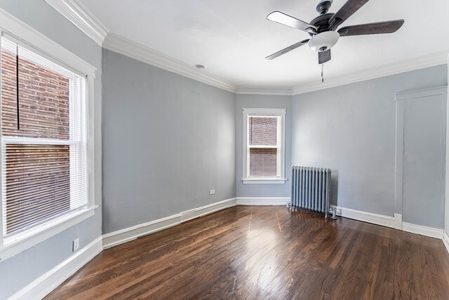 4820 West Wolfram Street, Unit 2 Chicago, IL 60641 - Photo 11 of 17 a view of wooden floor and windows in a room