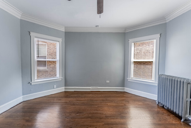 4820 West Wolfram Street, Unit 2 Chicago, IL 60641 - Photo 12 of 17 a view of an empty room with wooden floor and a window