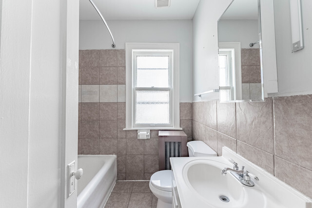 4820 West Wolfram Street, Unit 2 Chicago, IL 60641 - Photo 7 of 17 a bathroom with a sink and a toilet