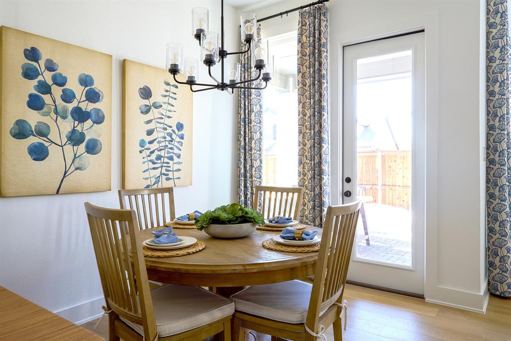 651 Caprice Bluff Fate, TX 75189 - Photo 11 of 26 a view of a dining room with furniture window and wooden floor
