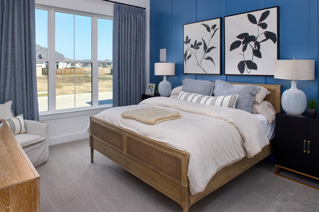 651 Caprice Bluff Fate, TX 75189 - Photo 12 of 26 a bed sitting in a bedroom next to a window