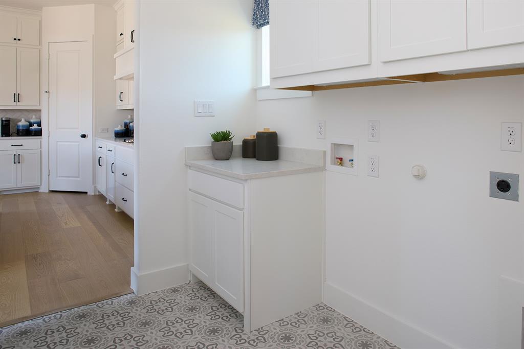 651 Caprice Bluff Fate, TX 75189 - Photo 16 of 26 a kitchen with stainless steel appliances white cabinets and a counter top