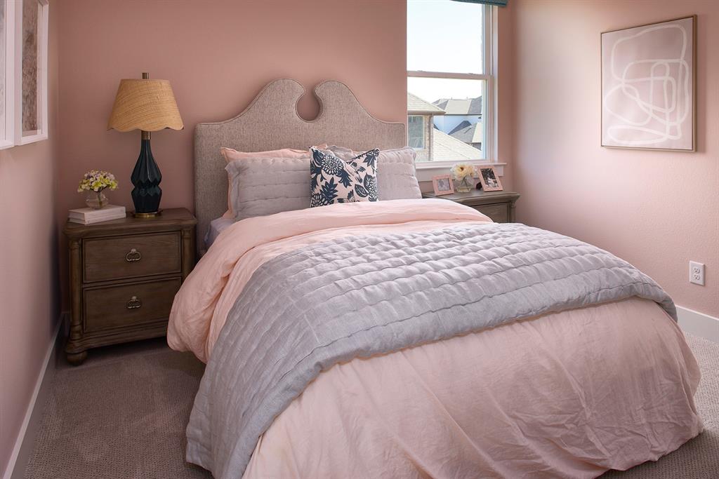 651 Caprice Bluff Fate, TX 75189 - Photo 19 of 26 a bedroom with a bed and a window