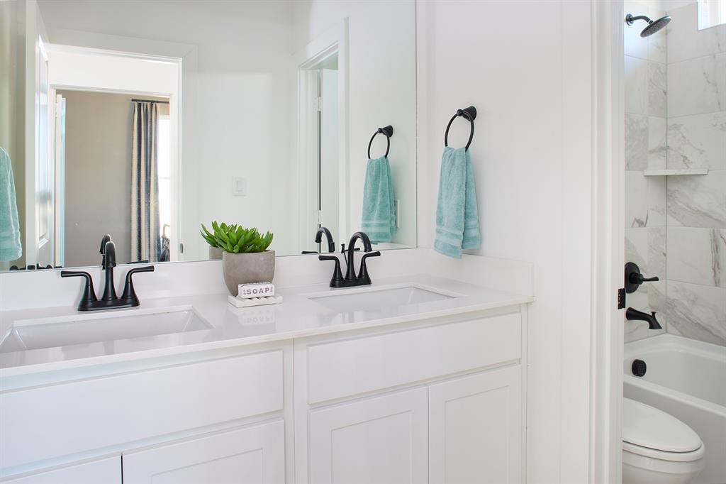 651 Caprice Bluff Fate, TX 75189 - Photo 20 of 26 a bathroom with a sink and a mirror
