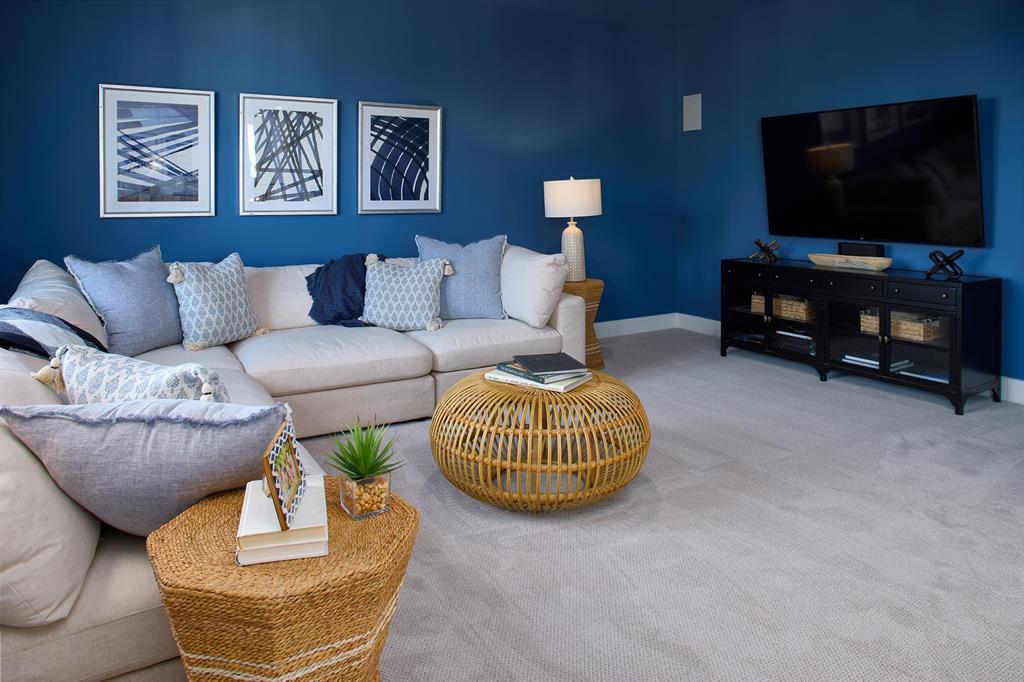 651 Caprice Bluff Fate, TX 75189 - Photo 23 of 26 a living room with furniture and a flat screen tv