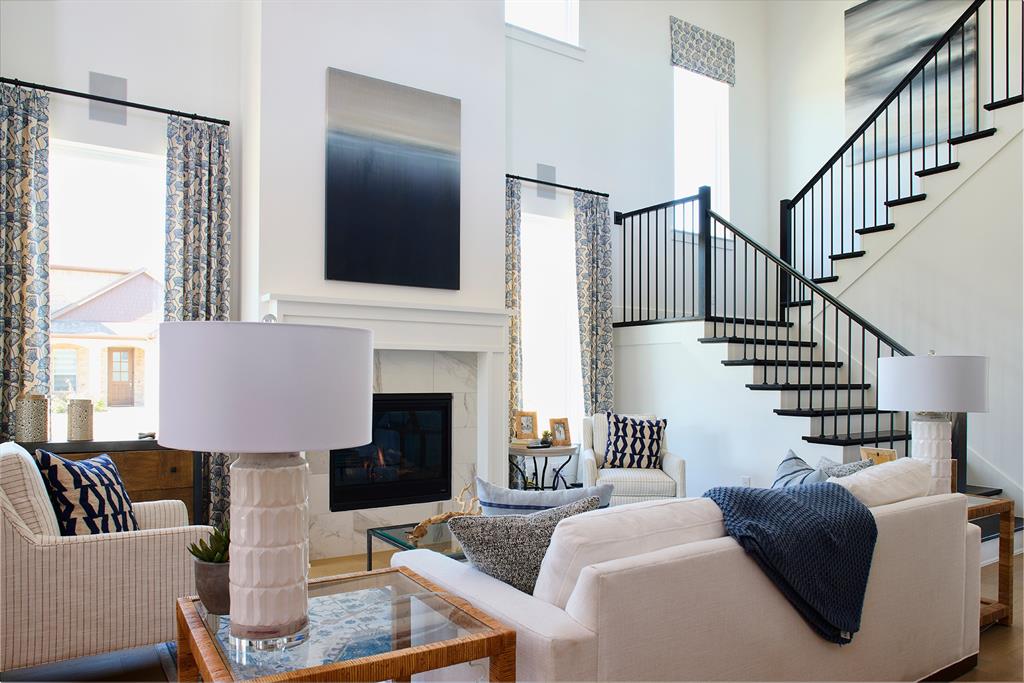 651 Caprice Bluff Fate, TX 75189 - Photo 5 of 26 a living room with furniture fireplace and a large window