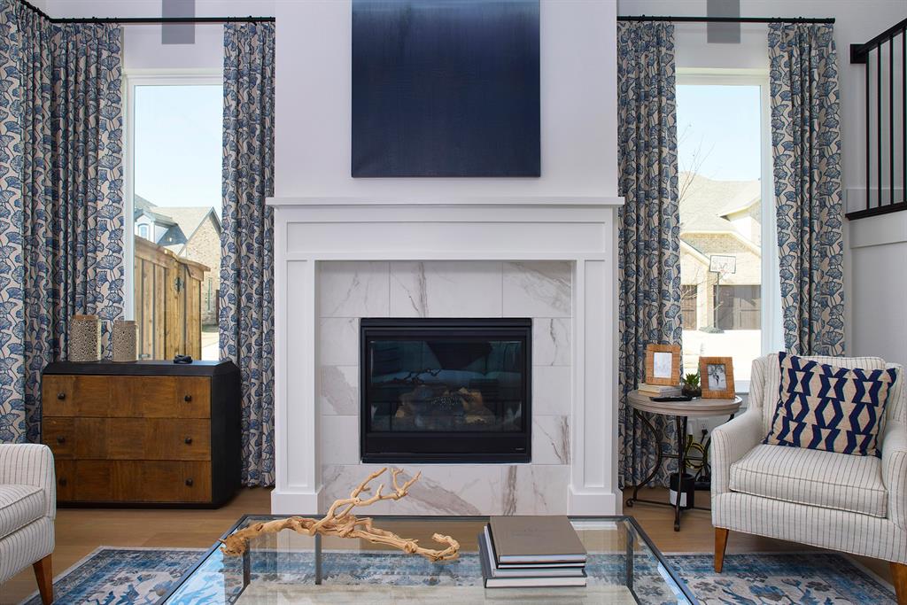 651 Caprice Bluff Fate, TX 75189 - Photo 6 of 26 a living room with furniture and a fireplace