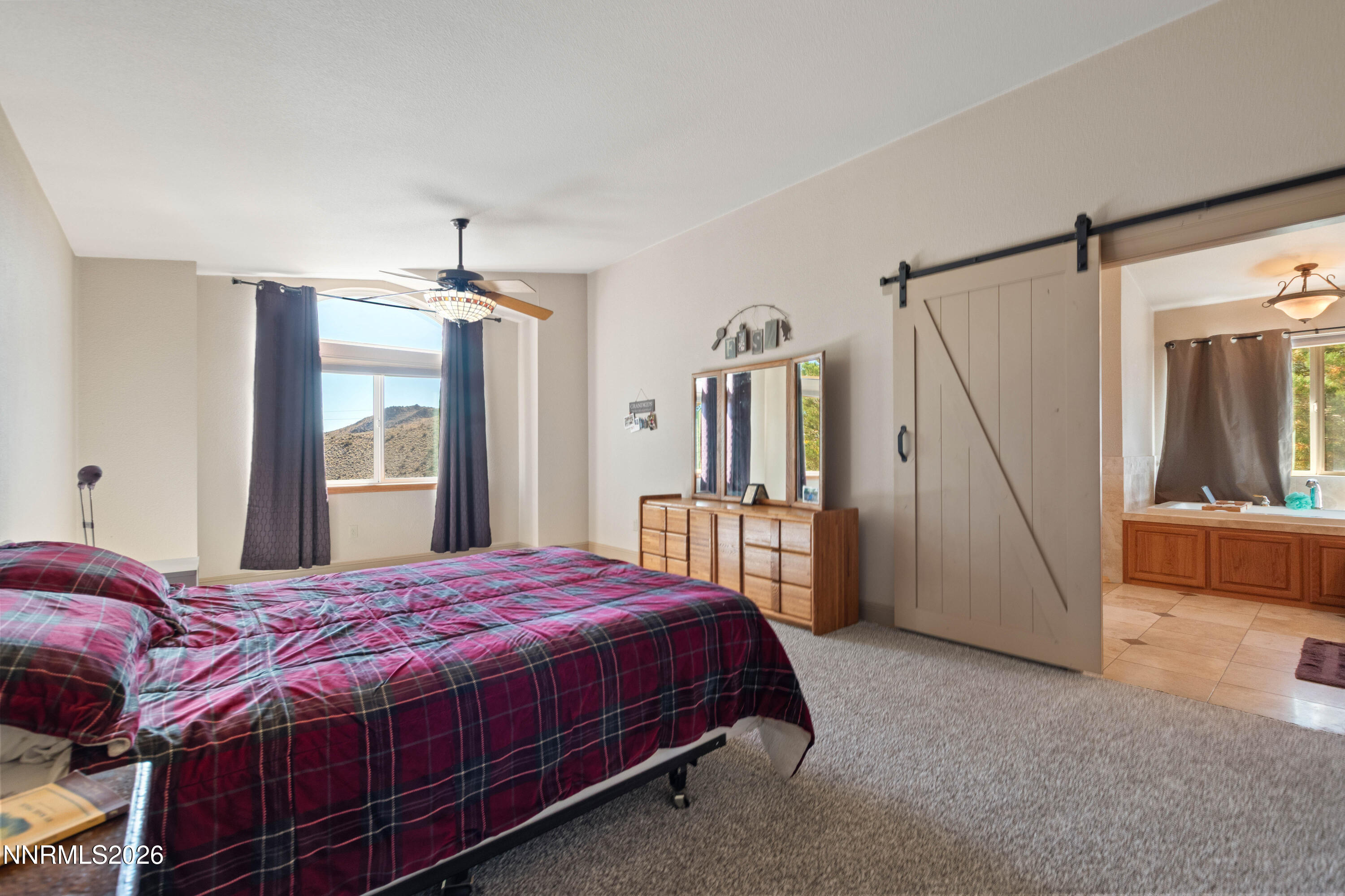 480 Duck Hill Road Washoe Valley, NV 89704 - Photo 11 of 27 a bedroom with a large bed and a window