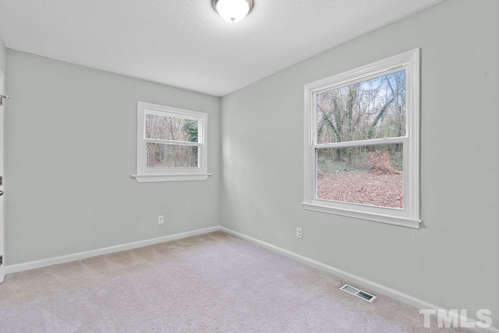 515 Dacian Road Raleigh, NC 27610 - Photo 14 of 21 a view of an empty room with windows