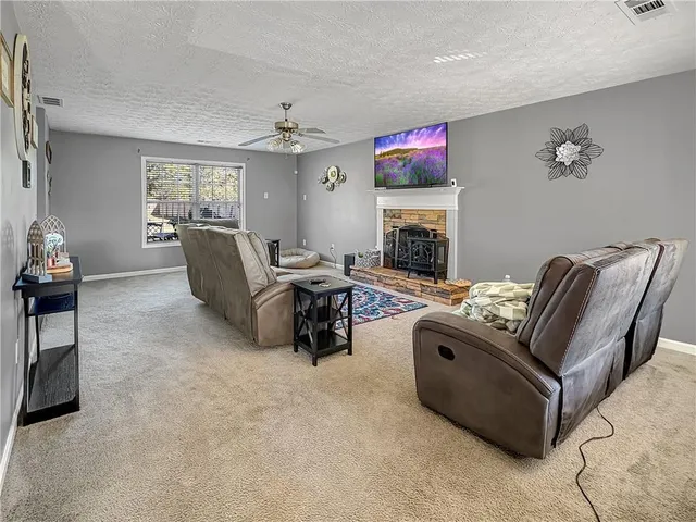 a living room with furniture fireplace and window