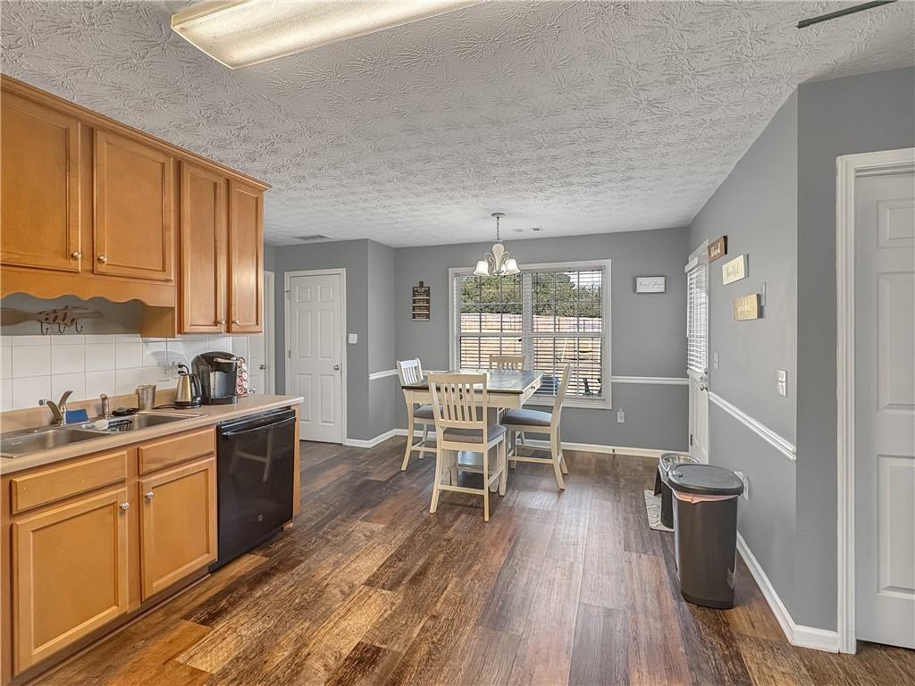 637 Sleeping Meadow Lane Bethlehem, GA 30620 - Photo 4 of 12 a kitchen with a table chairs wooden floors and white stainless steel appliances