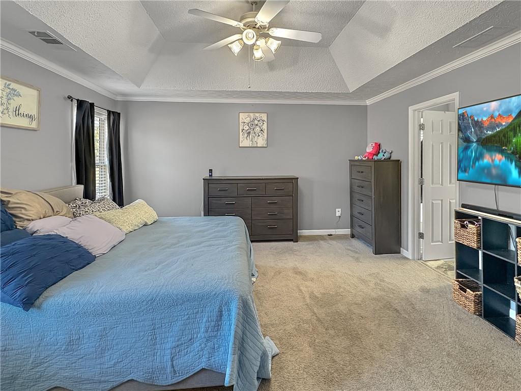 637 Sleeping Meadow Lane Bethlehem, GA 30620 - Photo 6 of 12 a bedroom with a bed and a flat screen tv