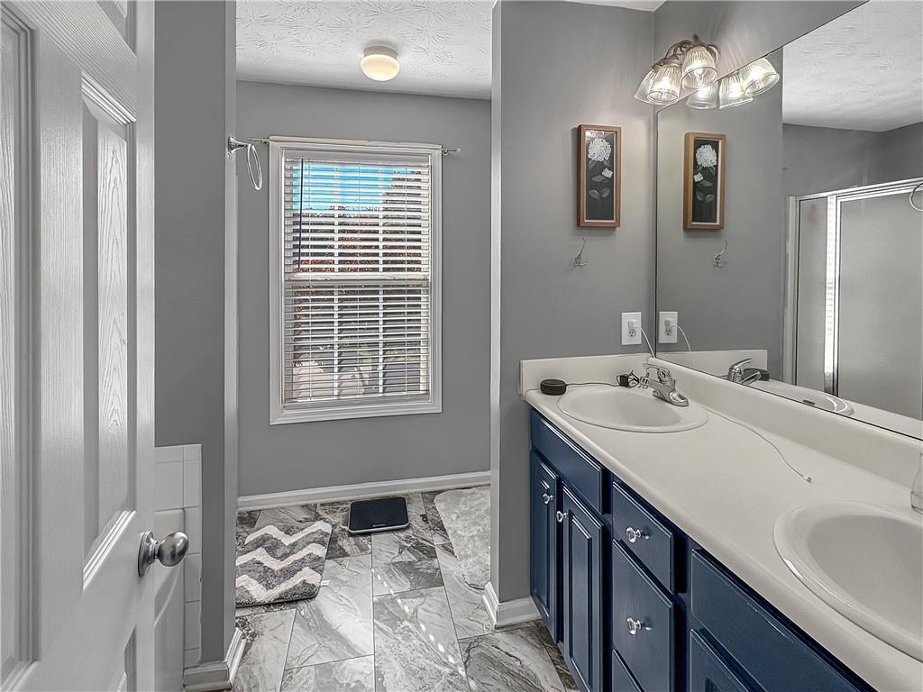 637 Sleeping Meadow Lane Bethlehem, GA 30620 - Photo 7 of 12 a bathroom with a sink and a mirror