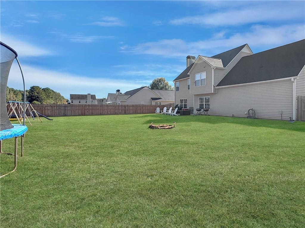 637 Sleeping Meadow Lane Bethlehem, GA 30620 - Photo 10 of 12 a backyard of a house with table and chairs