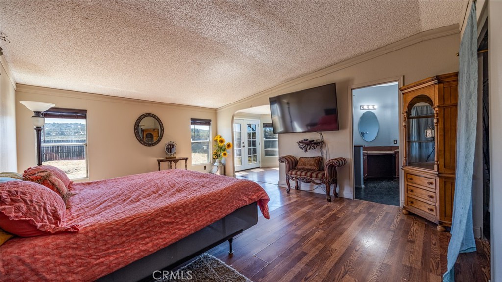 39550 Kirby Road Anza, CA 92539 - Photo 17 of 51 a bedroom with a bed and wooden floor