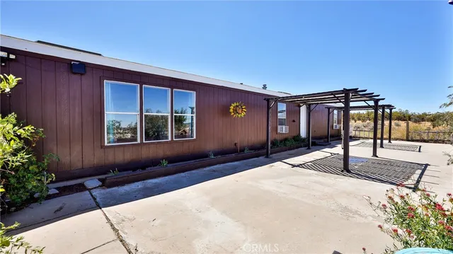 a kitchen with stainless steel appliances granite countertop a refrigerator a sink dishwasher a stove and a dining table with wooden floor