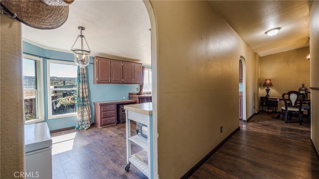 39550 Kirby Road Anza, CA 92539 - Photo 7 of 51 a view of a hallway with wooden floor windows a chandelier and livingroom