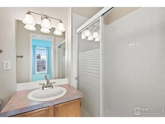 a bathroom with a sink vanity and a mirror