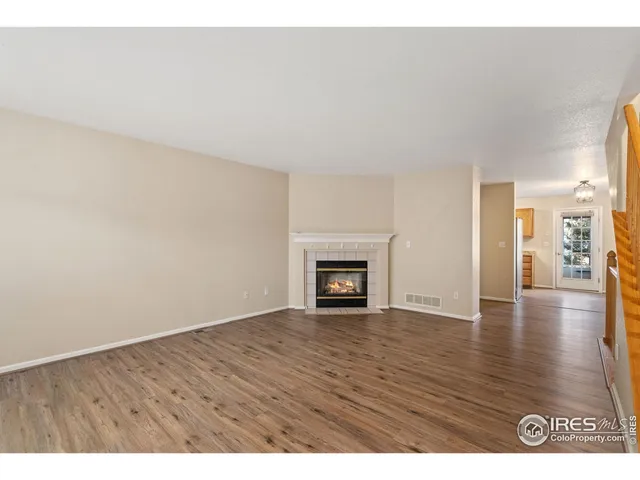 a view of an empty room and wooden floor