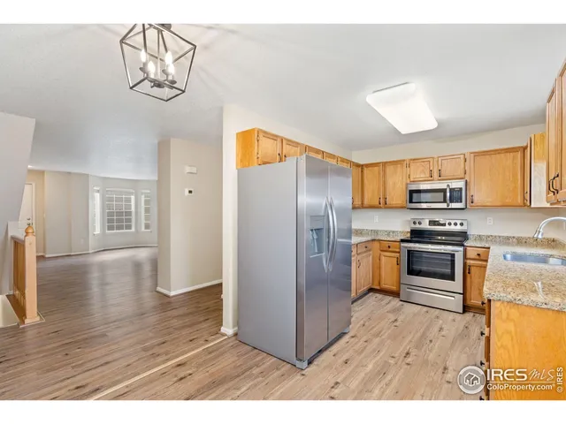 a kitchen with stainless steel appliances a refrigerator and a stove top oven