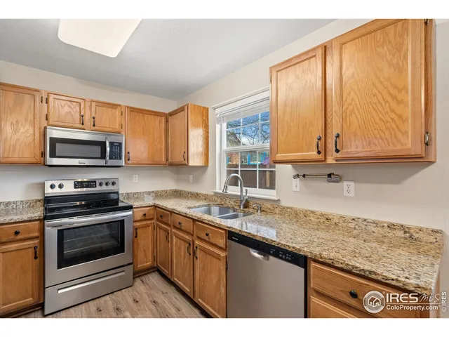 a kitchen with stainless steel appliances granite countertop a sink a stove and microwave