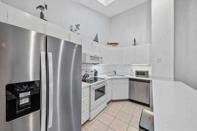 a kitchen with stainless steel appliances a refrigerator sink and cabinets