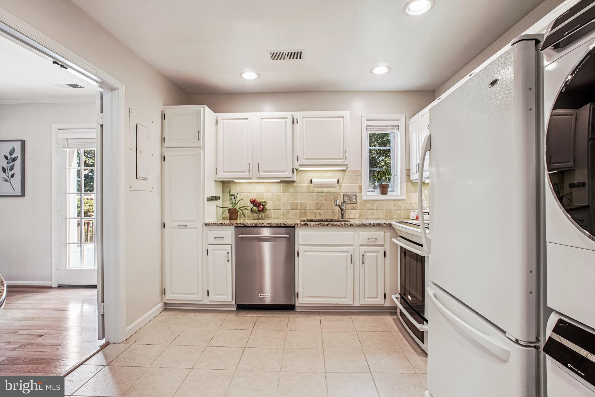 6719 Fairfax Road, Unit 67 Chevy Chase, MD 20815 - Photo 12 of 24 a kitchen with a refrigerator sink and cabinets