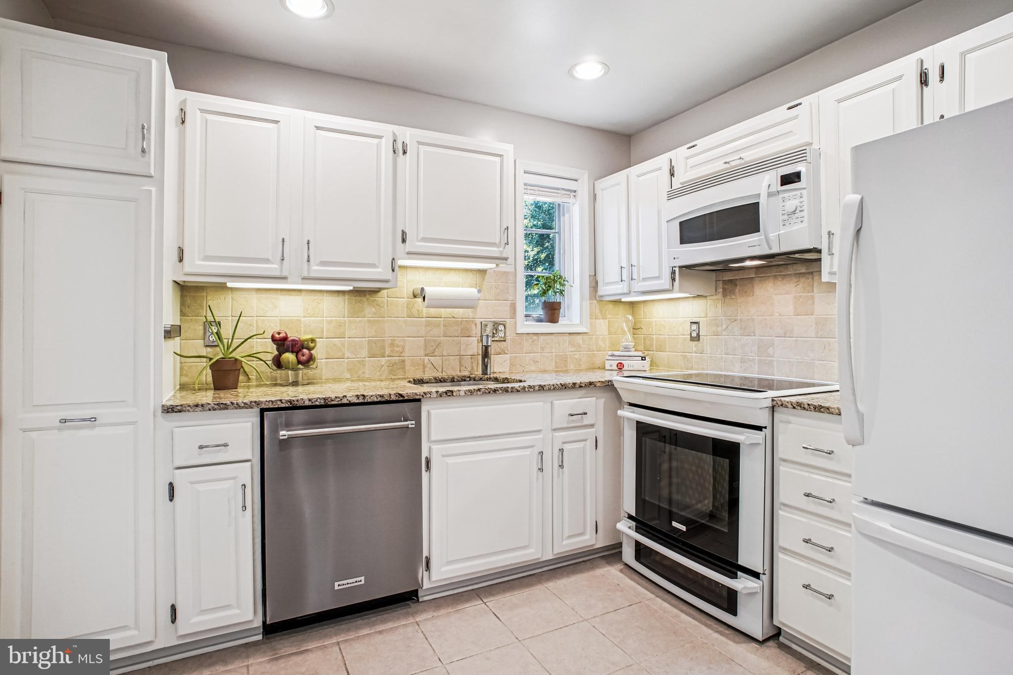 6719 Fairfax Road, Unit 67 Chevy Chase, MD 20815 - Photo 13 of 24 a kitchen with stainless steel appliances granite countertop a stove a sink and a microwave