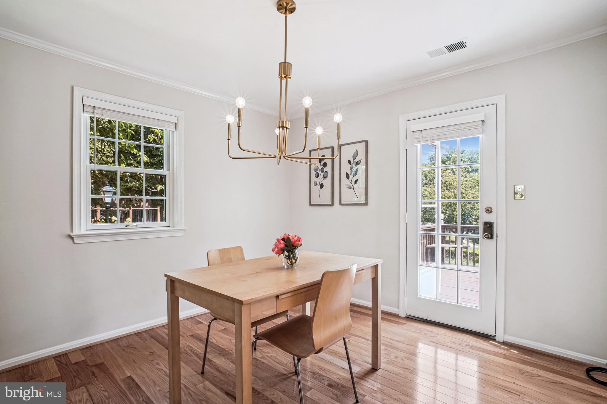 6719 Fairfax Road, Unit 67 Chevy Chase, MD 20815 - Photo 14 of 24 a view of a dining room with furniture window and wooden floor