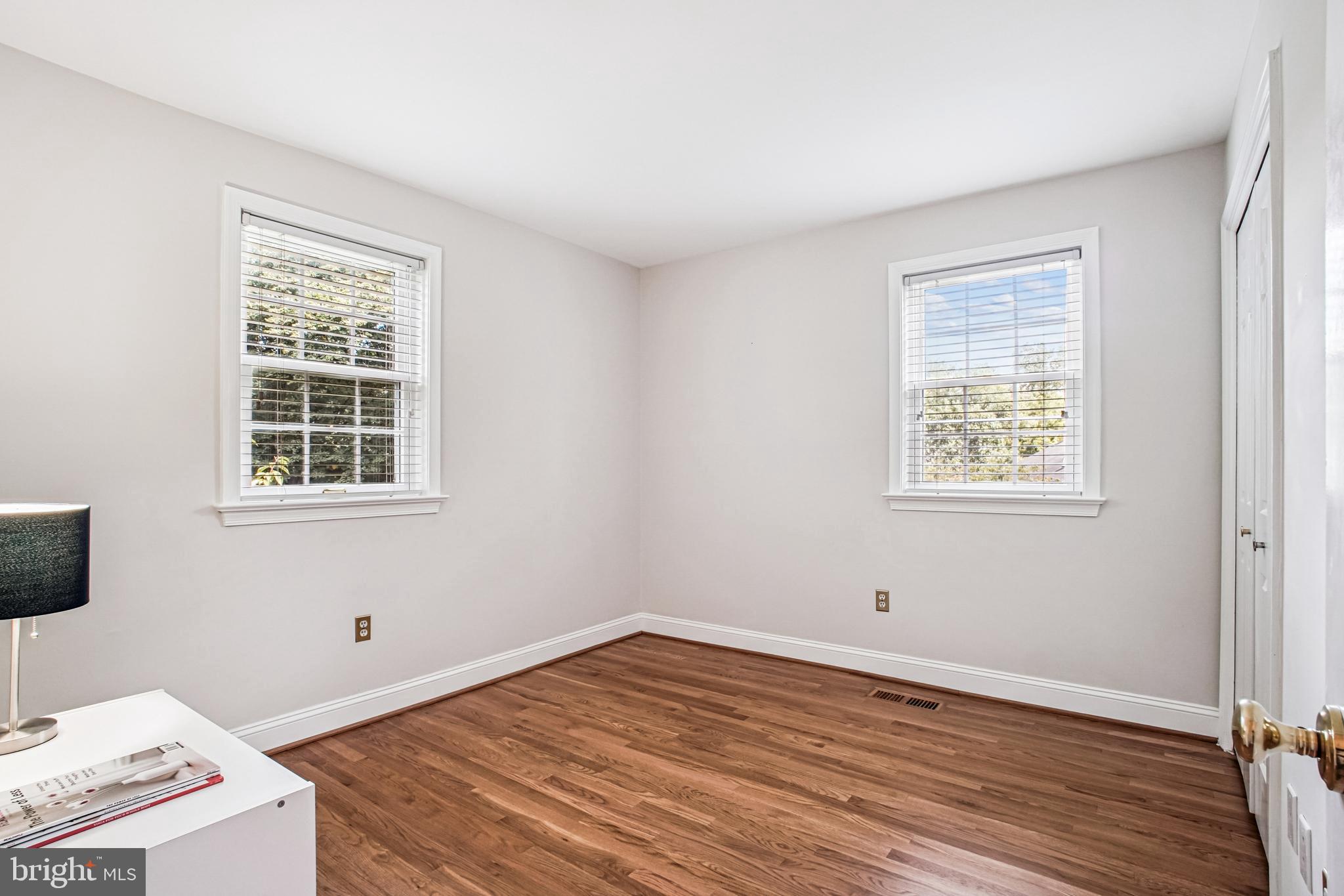 6719 Fairfax Road, Unit 67 Chevy Chase, MD 20815 - Photo 16 of 24 a view of a room with wooden floor and windows